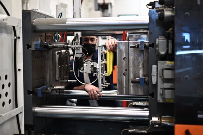 A worker operates machinery at a factory in Trezzano sul Naviglio, near Milan, Northern Italy, on June 25, 2021.