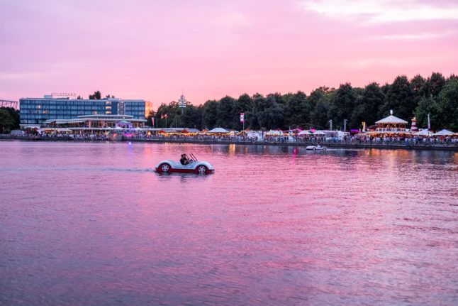 Visitors ride on a pedalo at Hannover's Maschsee festival.