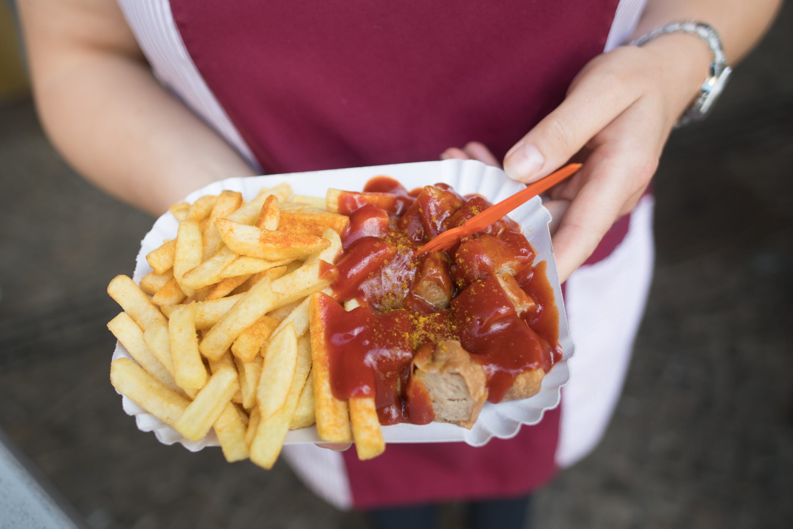 A plate of Currywurst and chips in Berlin.