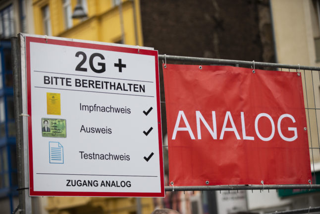 A sign at the Cologne carnival in February 2022 saying entry is '2G-plus' - only for vaccinated/recovered people who can show a negative test, or boosted people. 