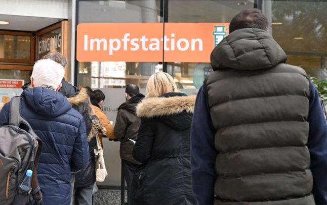 People queue for a Covid vaccination in Stuttgart in winter.