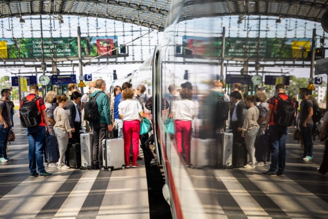 People queue to get on an ICE train at Berlin Hauptbahnhof.