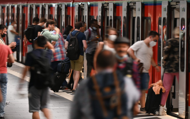 People get on and off an S-Bahn train at Frankfurt main station.