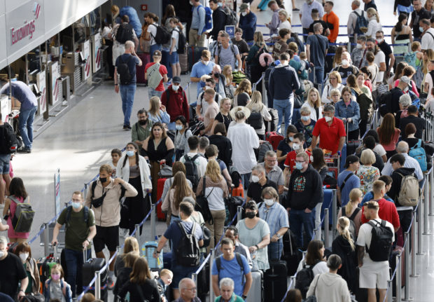 Passengers queue at Düsseldorf airport at the weekend.