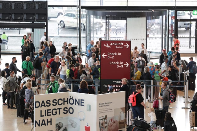 People arrive at Berlin Brandenburg airport in July.