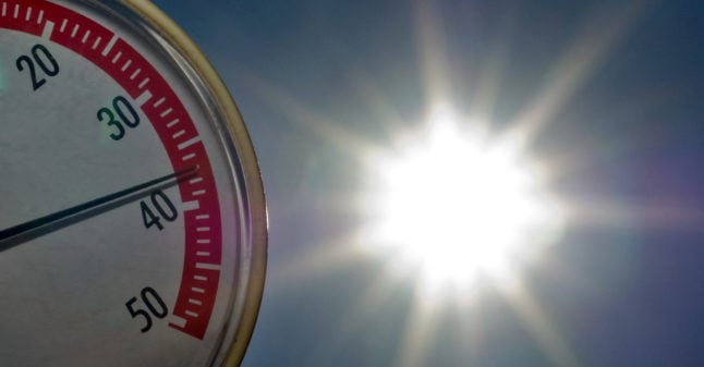 A thermometer shows 37C in front of the sun in an allotment garden in Frankfurt Oder.