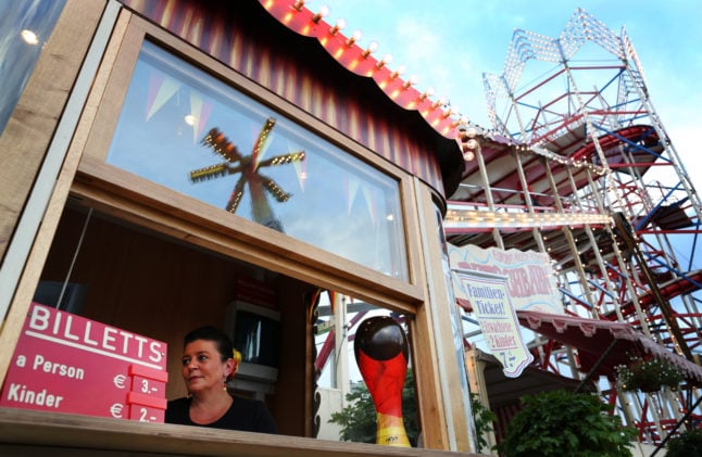 A woman sells fairground tickets at the Düsseldorf Rheinkirmes