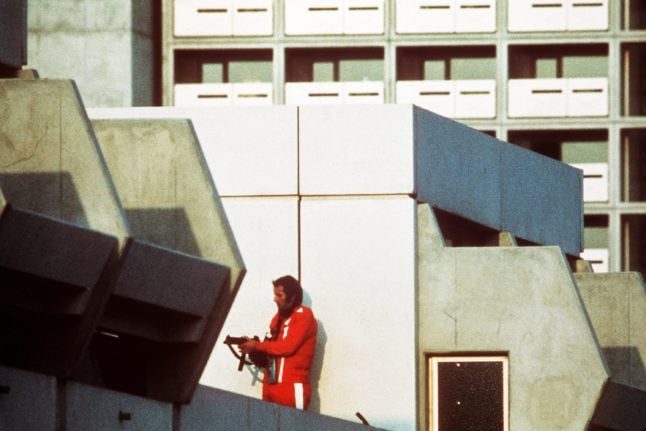 An armed police officer in a tracksuit secures the block where terrorists  held Israeli hostages at the Olympic Village in Munich on 5th September 1972.