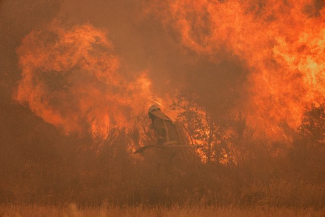 A firefighter operates at the site of a wildfire in Spain.