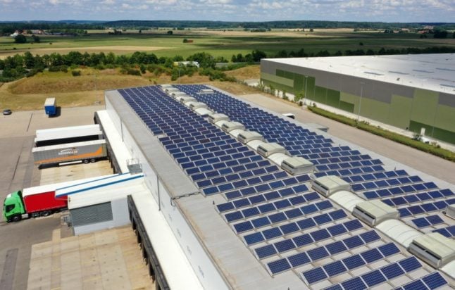 This aerial view taken with a drone shows solar panels on the roof of a logistics company's freight processing hall in Aurach, southern Germany.