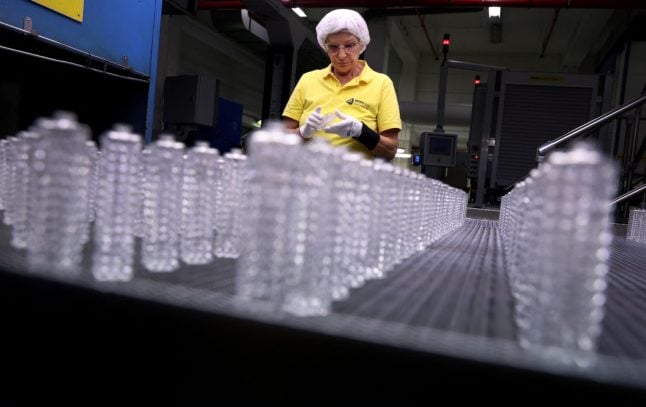 Quality controller Michaela Trebes inspects flacons on an assembly line at the German glass producer Heinz-Glas Group in Kleintettau, Germany on August 3rd 2022.