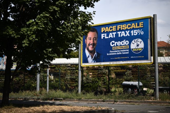 A photo taken on August 15, 2022 in Turin shows a campaign poster of the League party leader Matteo Salvini for the upcoming September general elections.