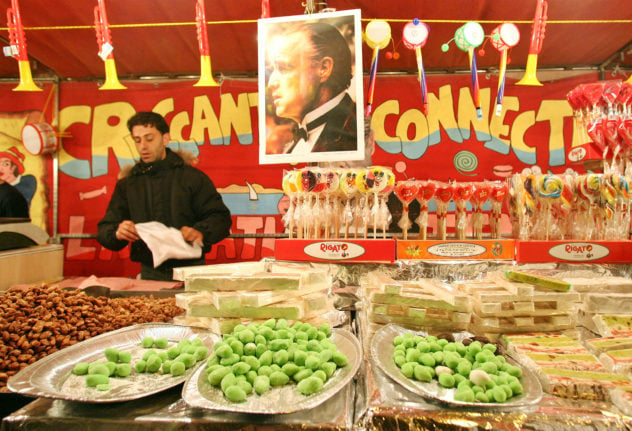 A man sells marzipan treats at a festa in Catania, Sicily.