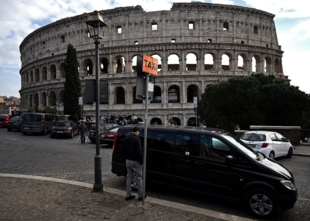 Taxi van parked in front of the Colosseum in Rome, Italy