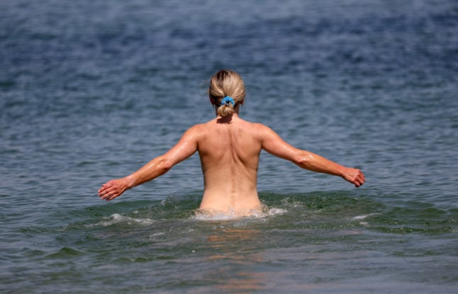 A woman goes swimming at a nudist section of the Baltic Sea resort in Rostock.