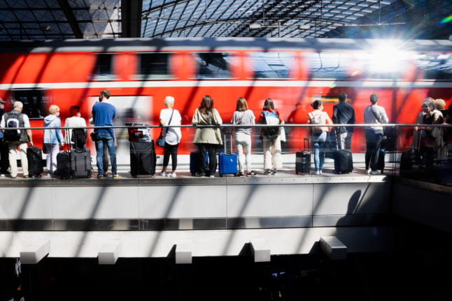 Passengers wait on the platform at Berlin Hauptbahnhof.