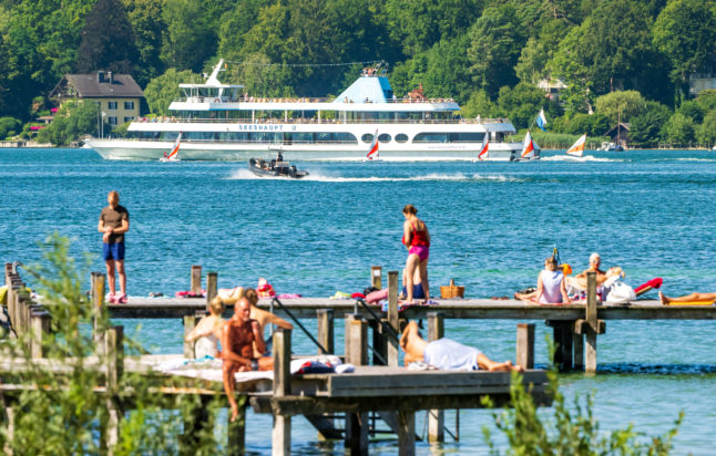 People enjoy warmer weather on a jetty in Lake Starnberg, Bavaria, on August 1st.
