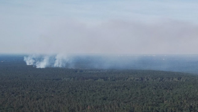 Smoke rises from the fire at the 'Grunewald' forest in Berlin.