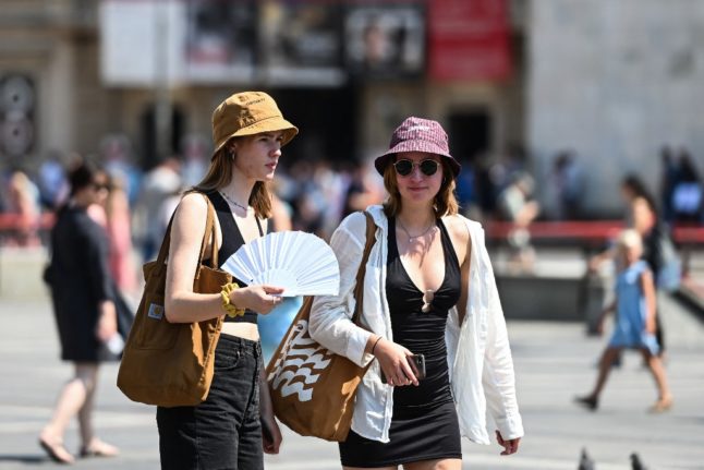 Tourists in a sunny Piazza Duomo, Milan