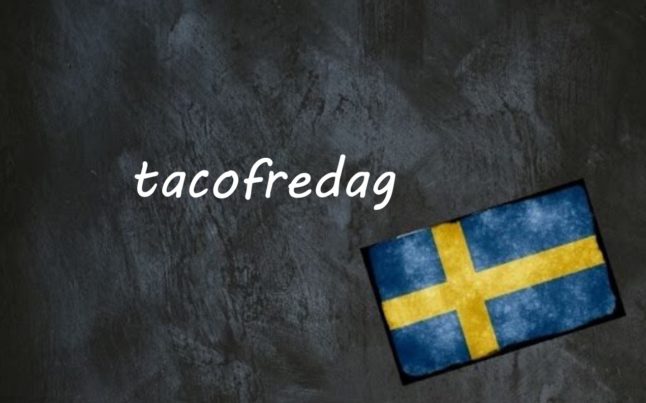 the word tacofredag written on a blackboard next to the swedish flag
