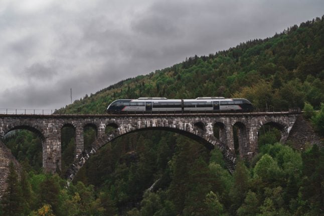 Pictured is a train passing over a viaduct in Norway.