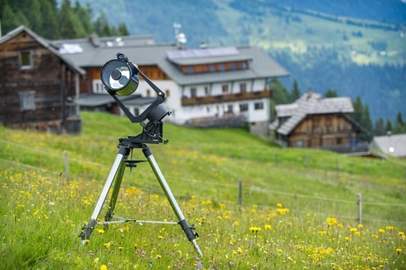 telescope in front of mountain residence