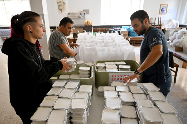 Volunteers prepare food at Mario Conte's San Francesco soup kitchen on September 20, 2022 in Salerno.