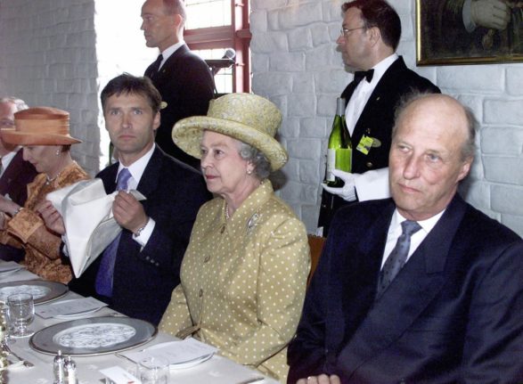 Pictured is King Haakon sat with Queen Elizabeth. 