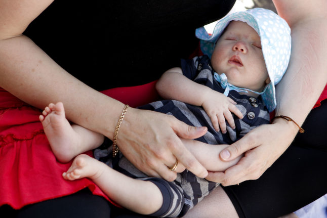 Newborn baby in mother's arms