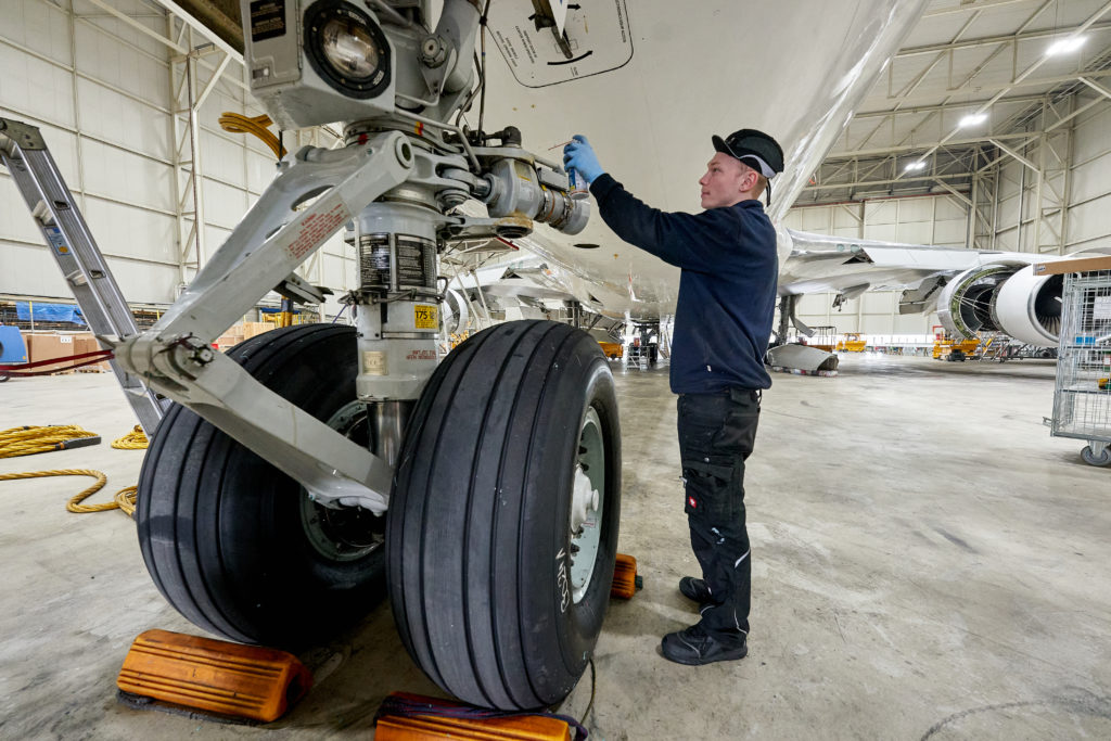 Sigudur, a native of Iceland, checks the landing gear of a Boeing 747 at the Haitec aircraft shipyard in Hahn. Germany is struggling with a skilled worker shortage.