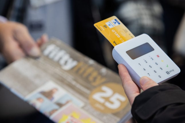 A customer pays with EC card in a local shop