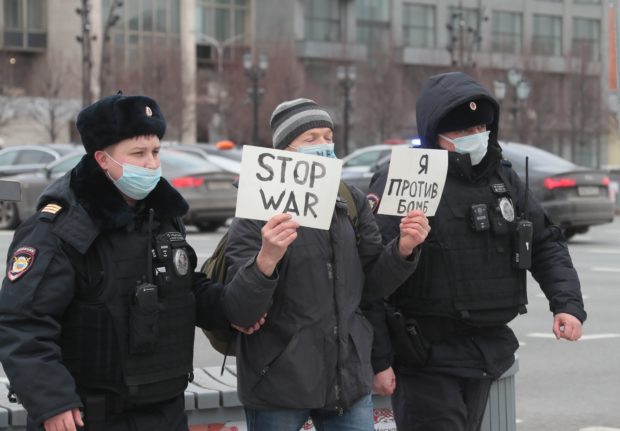 An anti-war protester is arrested in Moscow