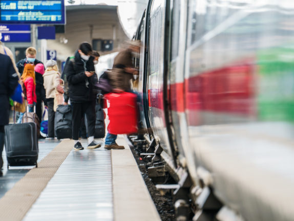 Travellers board a long-distance train in Frankfurt.