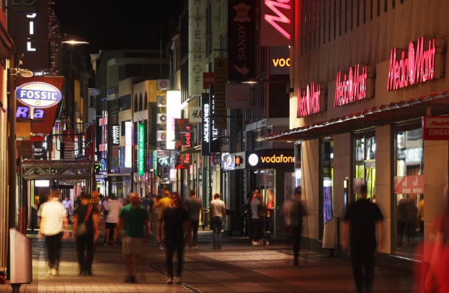 Neon signs are switched off on the Hohe Strasse in Cologne, in accordance with a new energy-saving regulation.