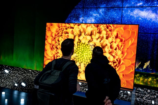 Visitors look at TVs at the stand of the LG brand at the electronics show IFA in Berlin.