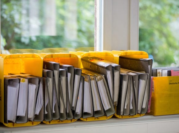 Folders filled with documents sit on a windowsill.