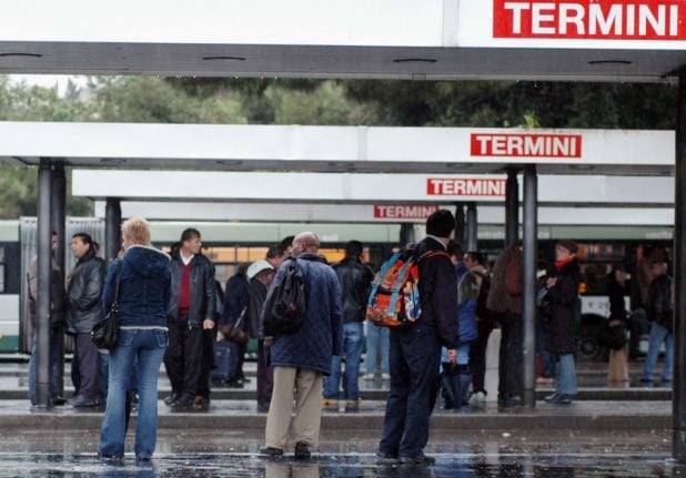 Passengers waiting for buses at a bus station in Rome.