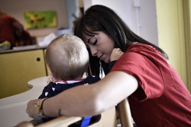 An educator takes care of a baby in the nursery of Bollate Penitentiary, on October 12, 2017 in Milan.