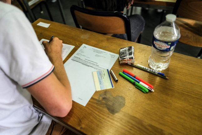A student completing a written test.