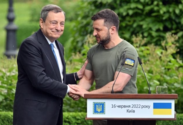 Prime minister of Italy Mario Draghi (L) shakes hands with Ukrainian President Volodymyr Zelensky following their meeting in Mariinsky Palace, in Kyiv, on June 16, 2022.