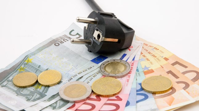 A power cable lies on a pile of euro notes.