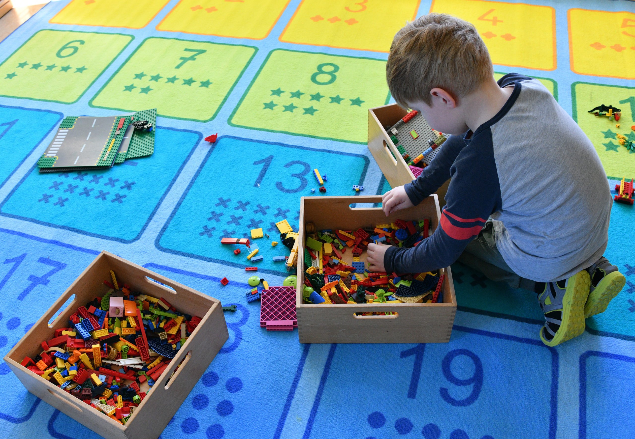 A young boy plays with bricks in a nursery school in Potsdam