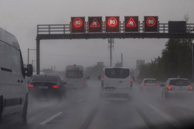 Cars drive on the A73 in Bavaria in the rain