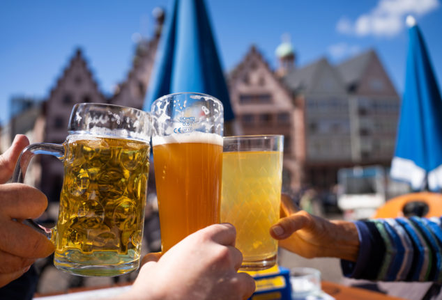 Three locals enjoy a beer in Frankfurt city centre.