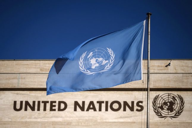 A flag of the United Nations flutters in wind at the main entrance of the 