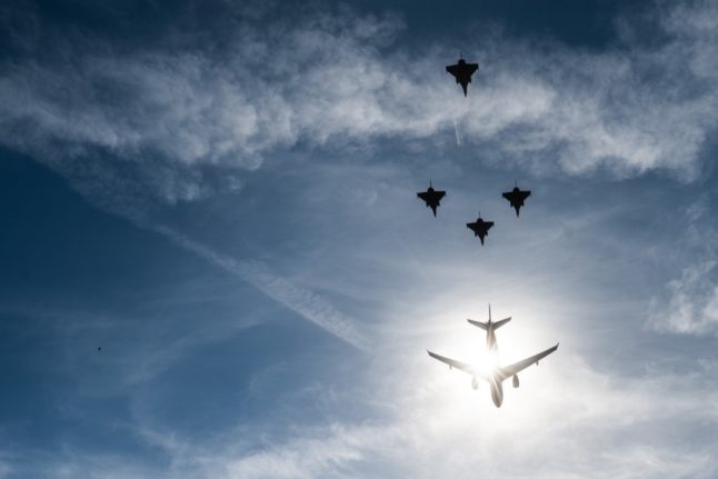 French Airbus A330 Multi Role Tanker Transport (MRTT) followed by French Air Force Dassault Rafale C multirole fighter aircrafts fly-over during the Bastille Day military parade in Paris