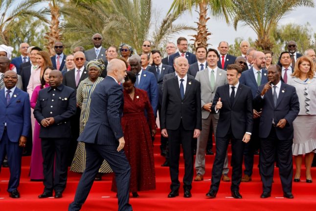 Albania's Prime Minister Edi Rama (C-L) arrives as Tunisia's President Kais Saied (3rd-R), France's President Emmanuel Macron (2nd-R) and Ivory Coast's President Alassane Dramane Ouattara (R) pose for a group picture during the 18th Francophone countries Summit