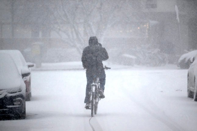 A cyclist battling heavy snow in Stockholm, November 2022