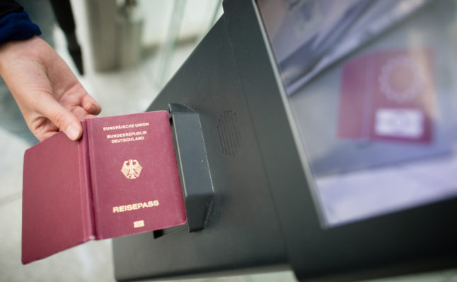 Woman scans German passport at e-gate