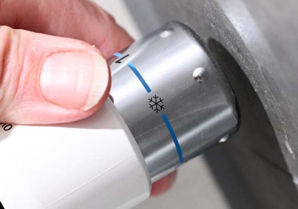 A person turning on their radiator in Germany.